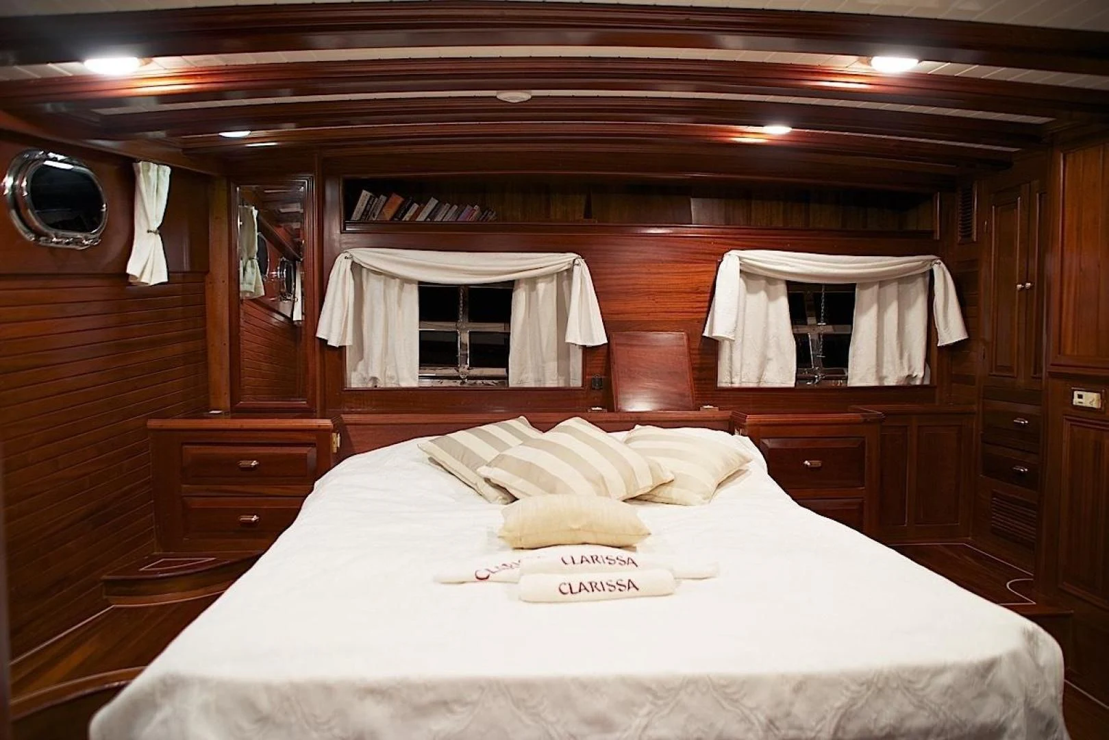 a bed with white sheets and pillows aboard CLARISSA Yacht for Sale