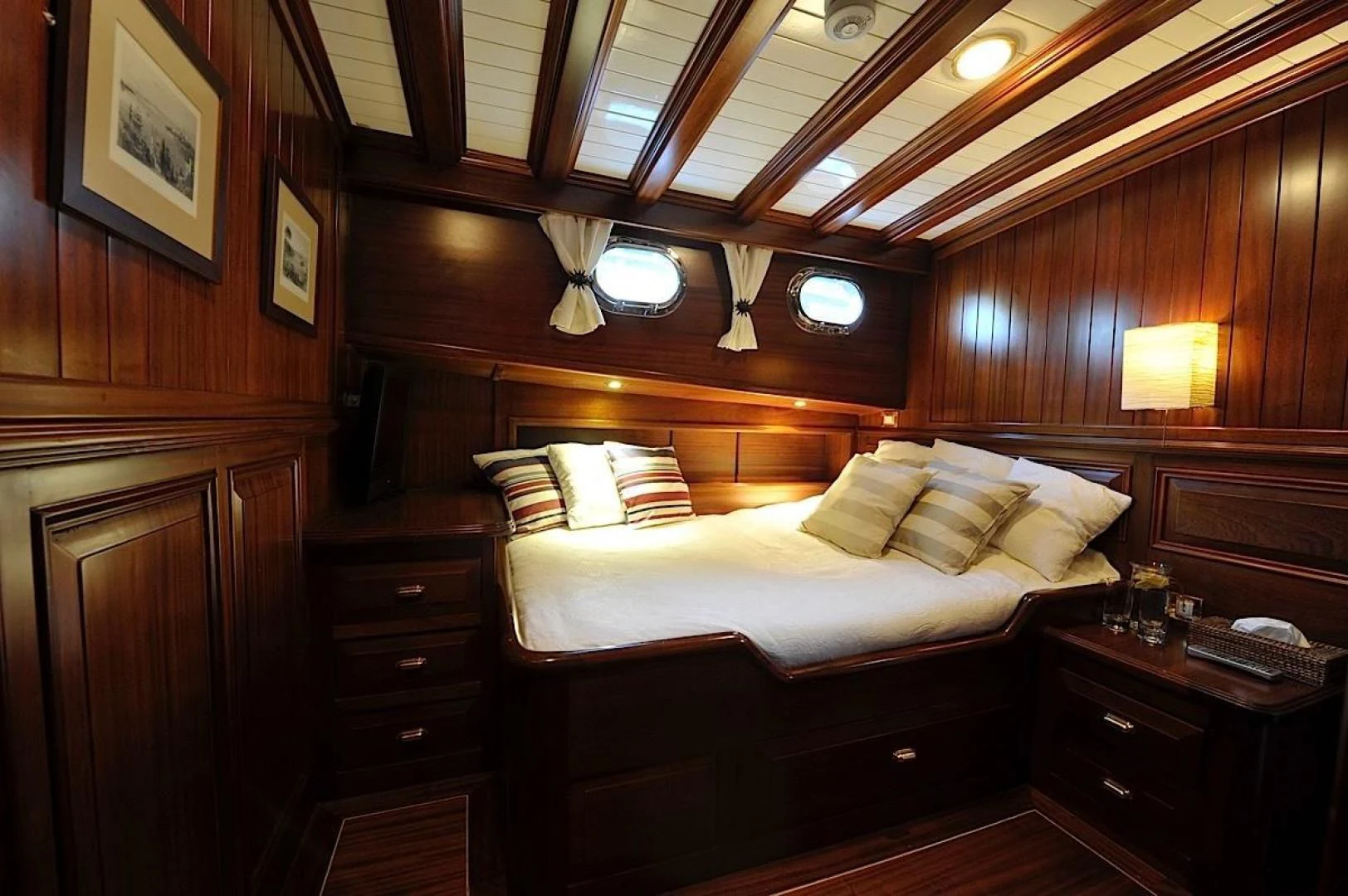 a bed with a wooden headboard aboard CLARISSA Yacht for Sale
