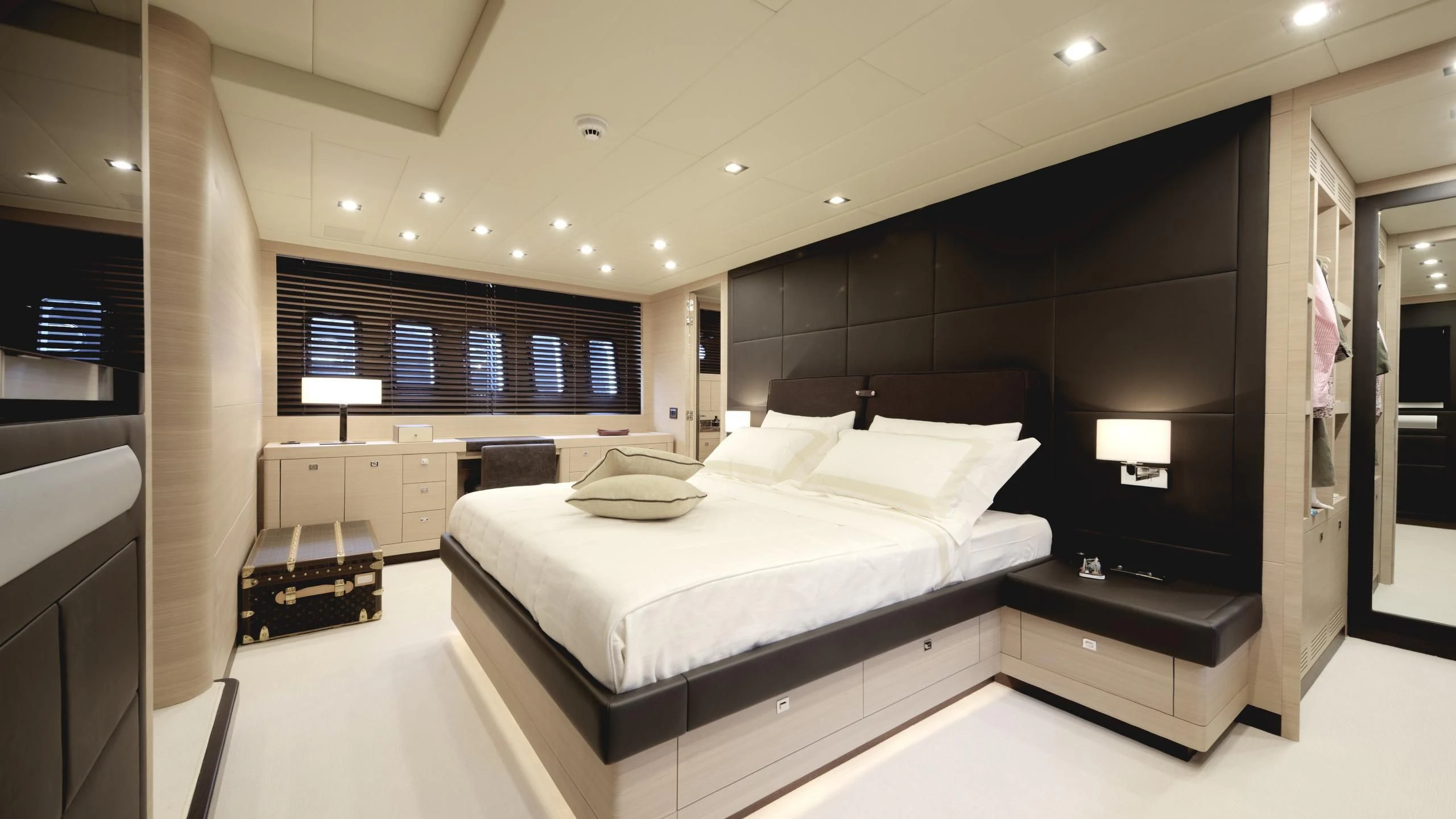 a room with a bed and desk aboard CLARISSA Yacht for Sale