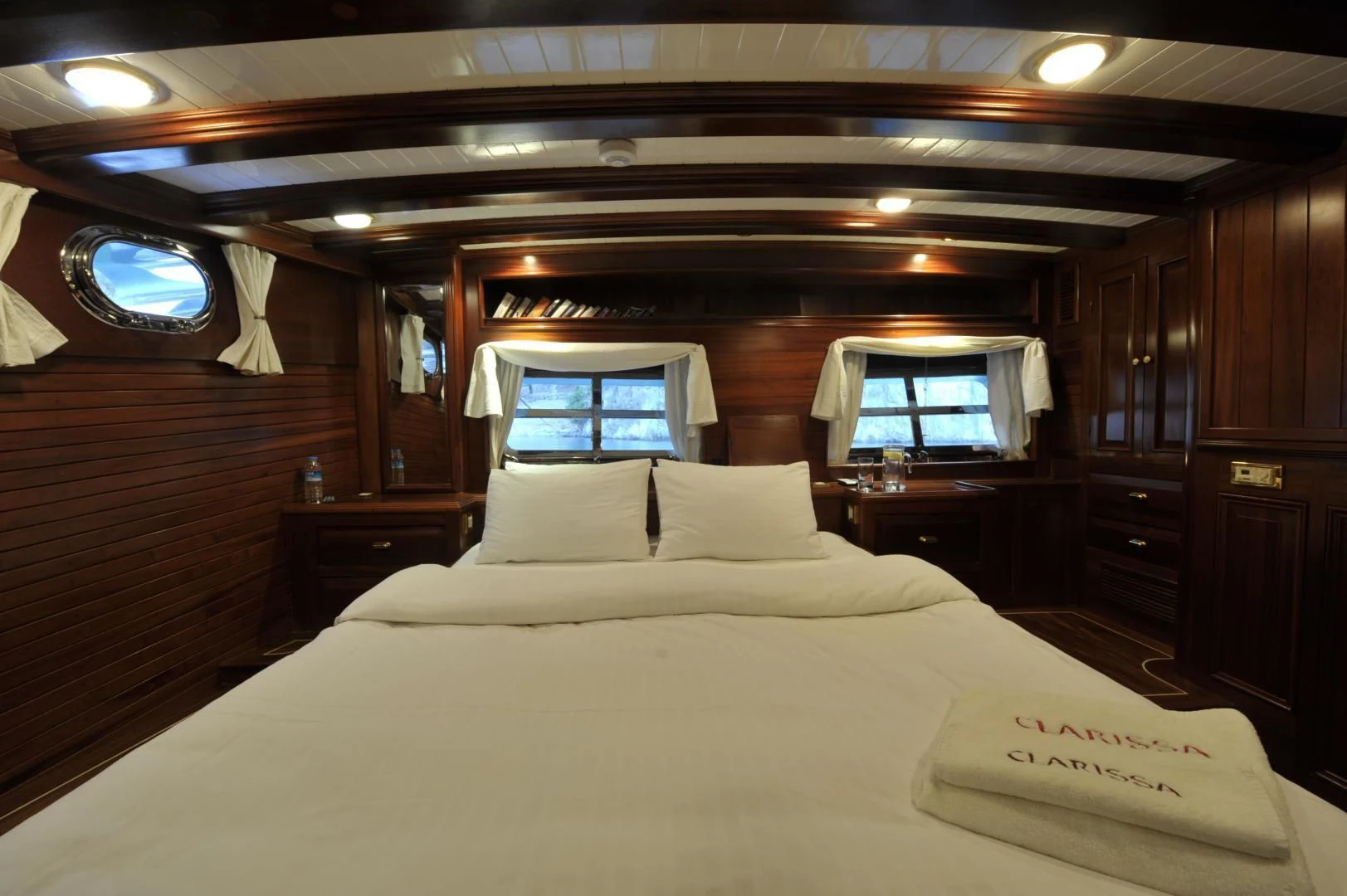 a bed with a white sheet and pillows in a cabin aboard CLARISSA Yacht for Sale