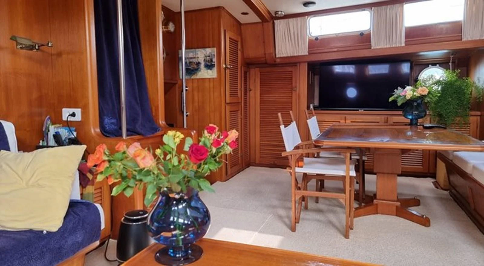 a living room with a table and chairs aboard ACOA Yacht for Sale