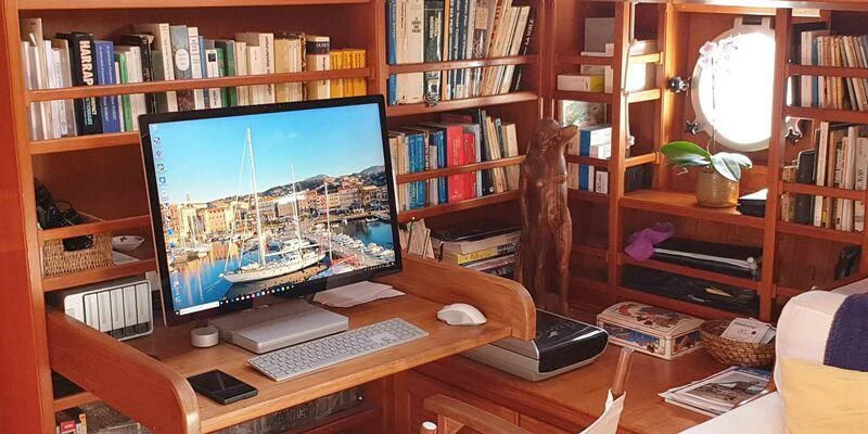 a computer on a desk aboard ACOA Yacht for Sale