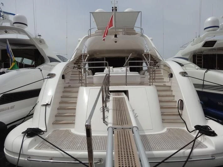 a white boat with a red stripe aboard WHISPERING ANGEL Yacht for Sale