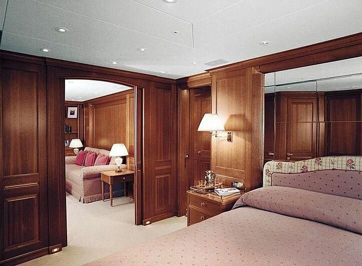 a room with a bed and a desk aboard ALMYRA II Yacht for Charter