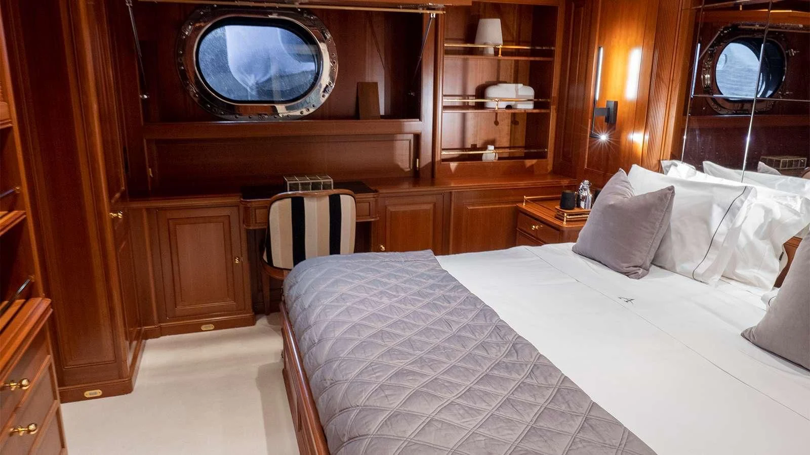 a room with a bed and a mirror aboard ALMYRA II Yacht for Charter