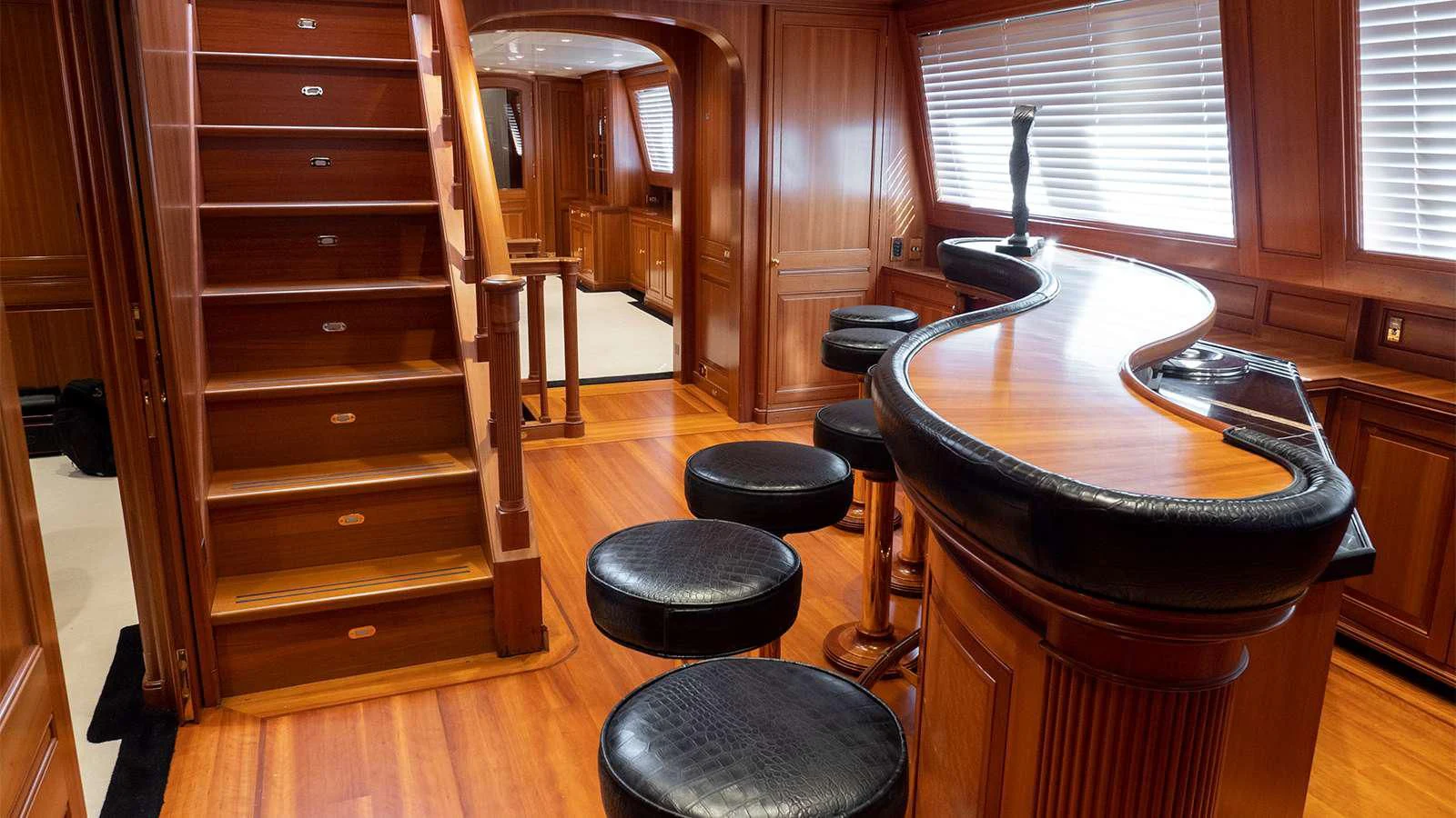 a room with a table and stools aboard ALMYRA II Yacht for Charter