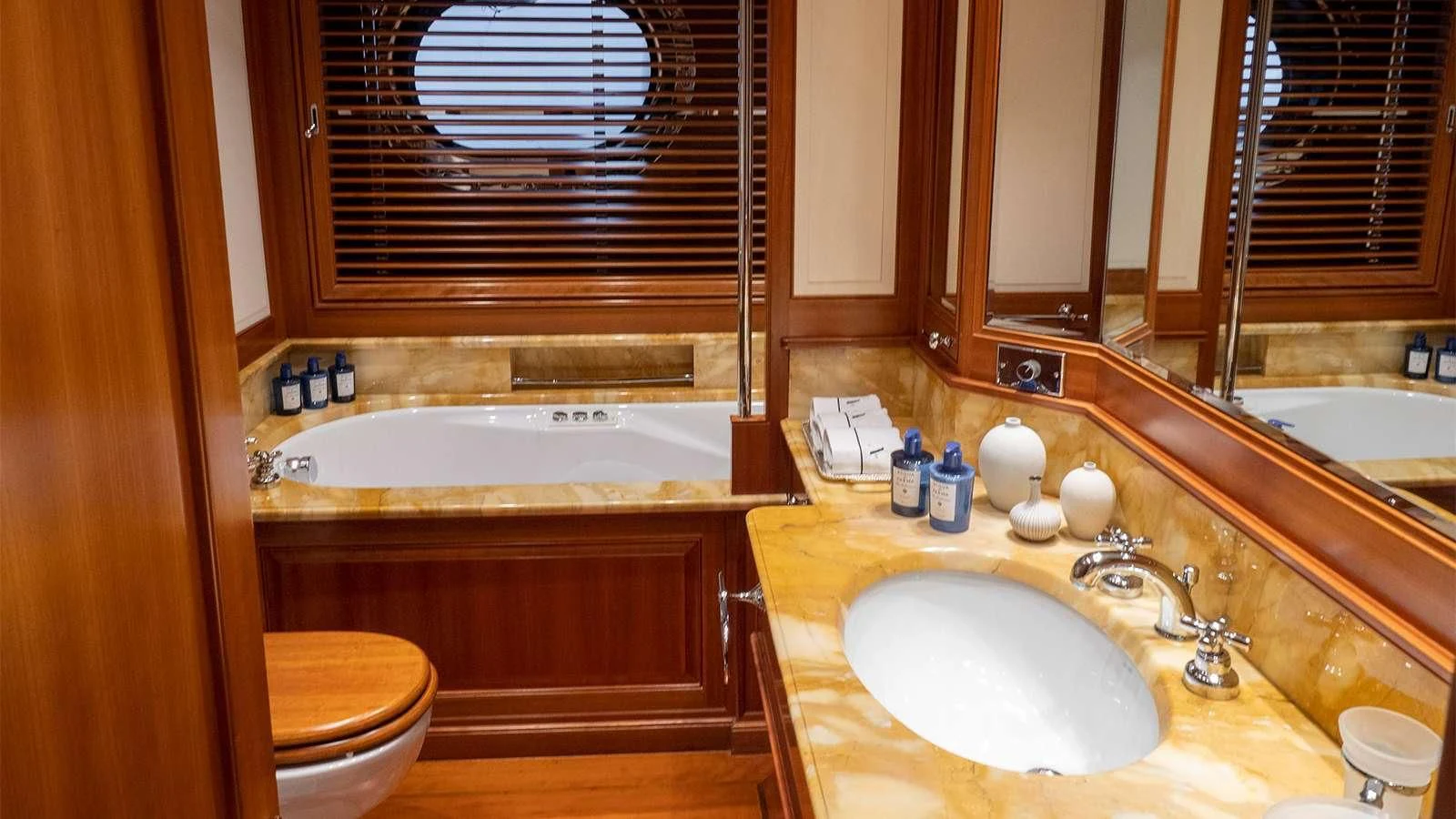 a bathroom with a tub sink and toilet aboard ALMYRA II Yacht for Charter
