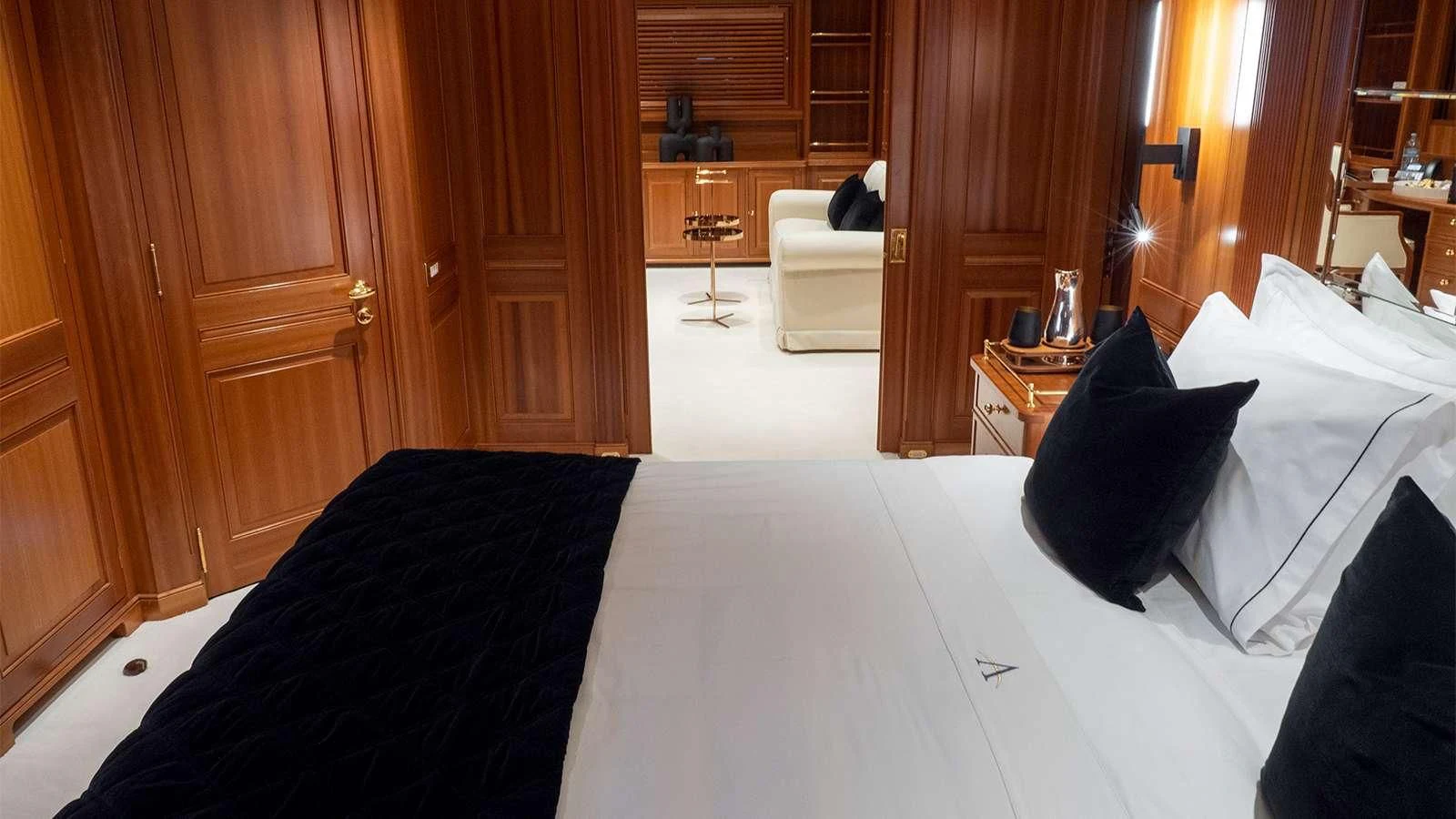 a room with a bed and a chair aboard ALMYRA II Yacht for Charter