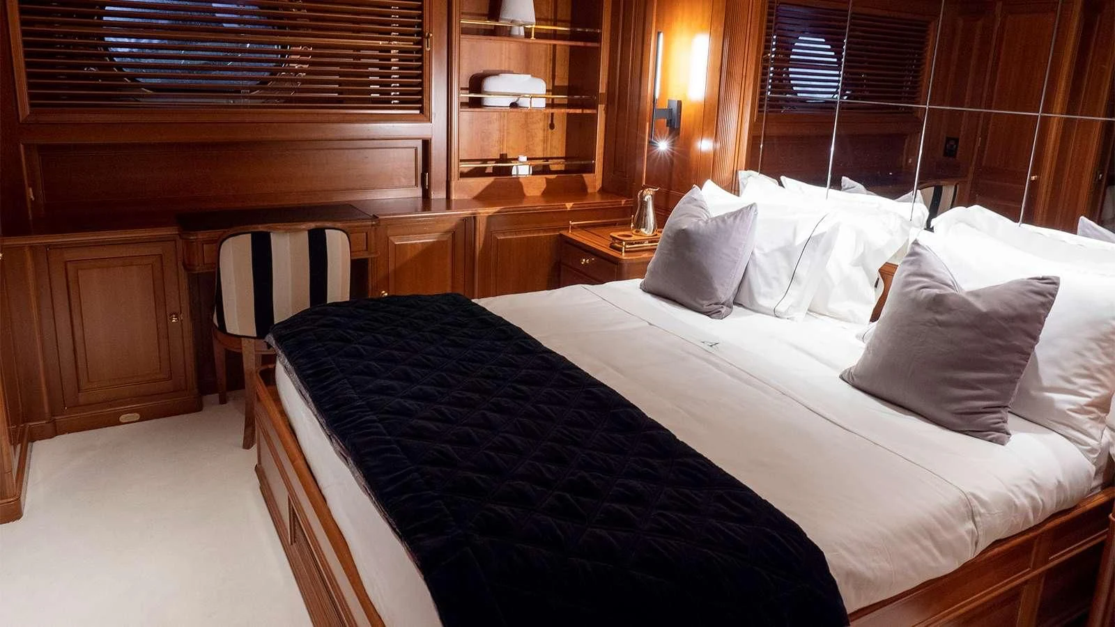 a bed with white sheets aboard ALMYRA II Yacht for Charter
