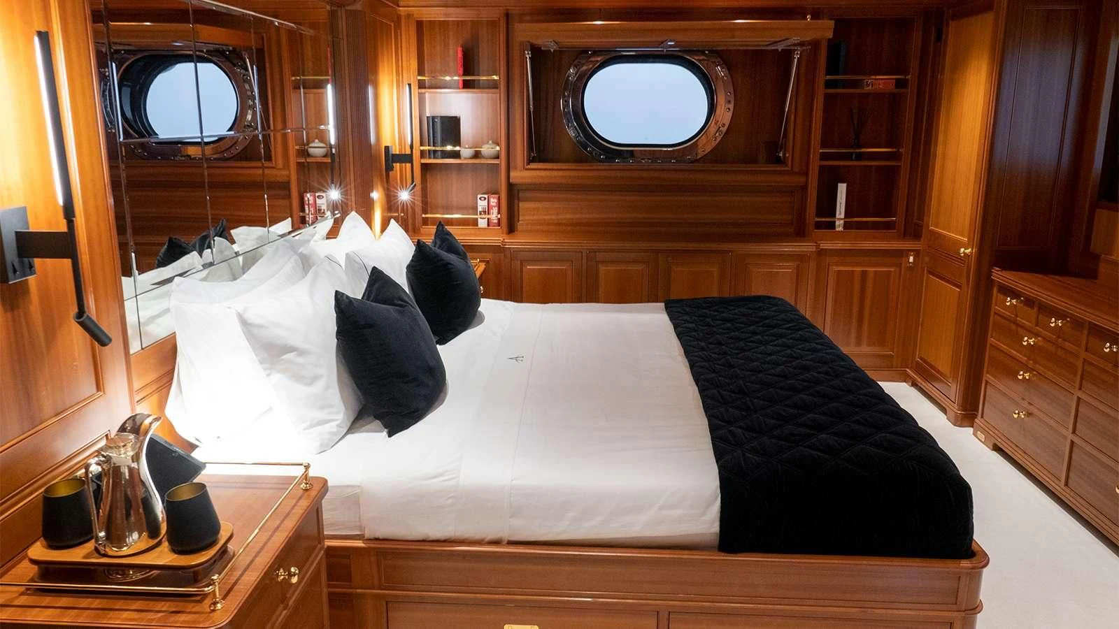 a bed with white sheets aboard ALMYRA II Yacht for Charter