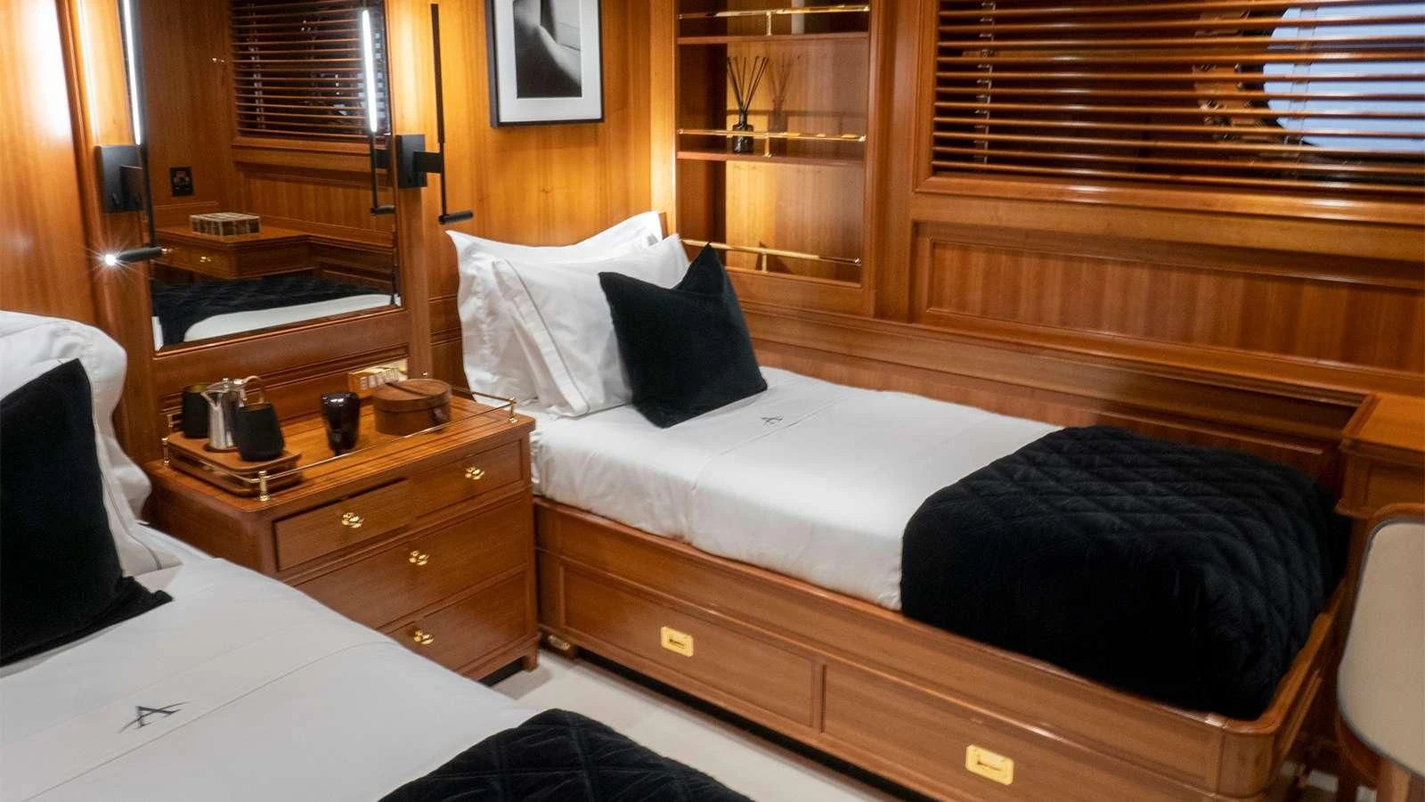 a room with a bed and a dresser aboard ALMYRA II Yacht for Charter