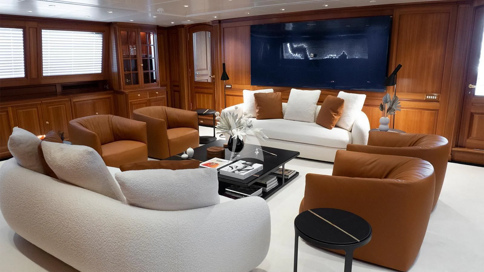 a living room with couches and a tv aboard ALMYRA II Yacht for Charter