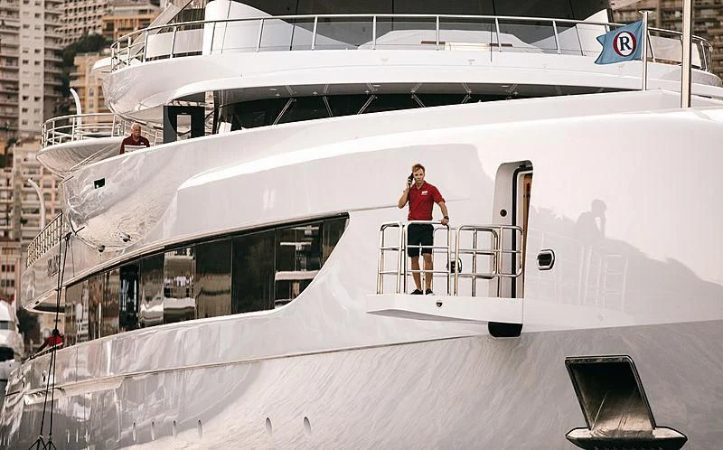 a person standing on a tall white boat aboard EXCELLENCE Yacht for Sale