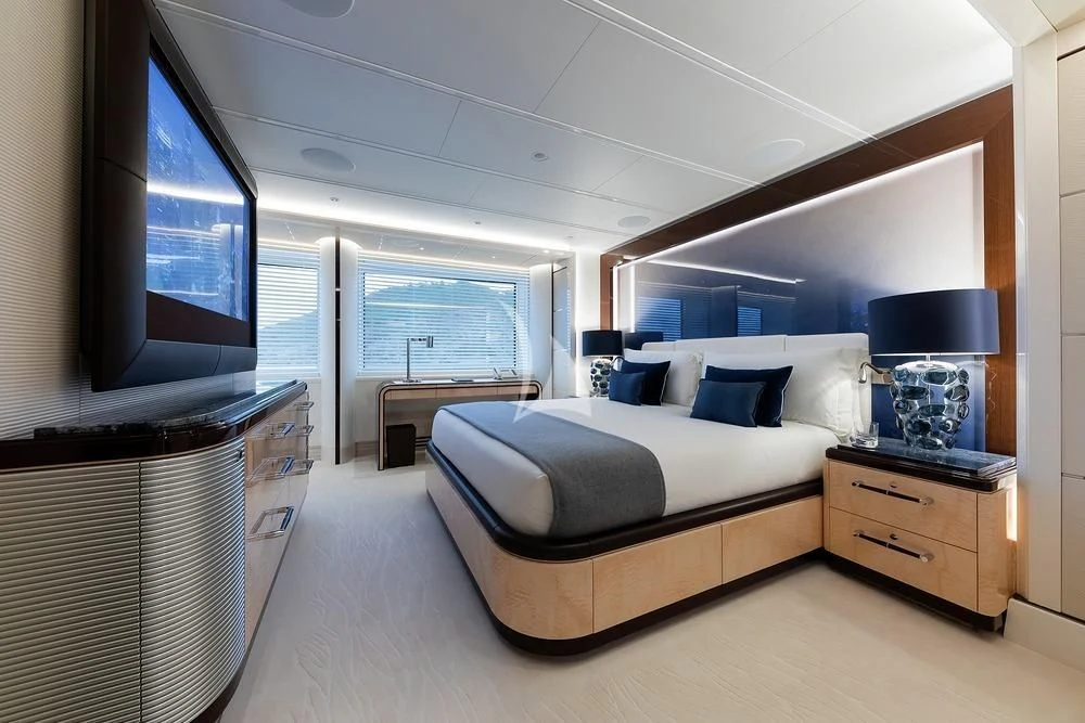 a bedroom with a large bed aboard EXCELLENCE Yacht for Sale