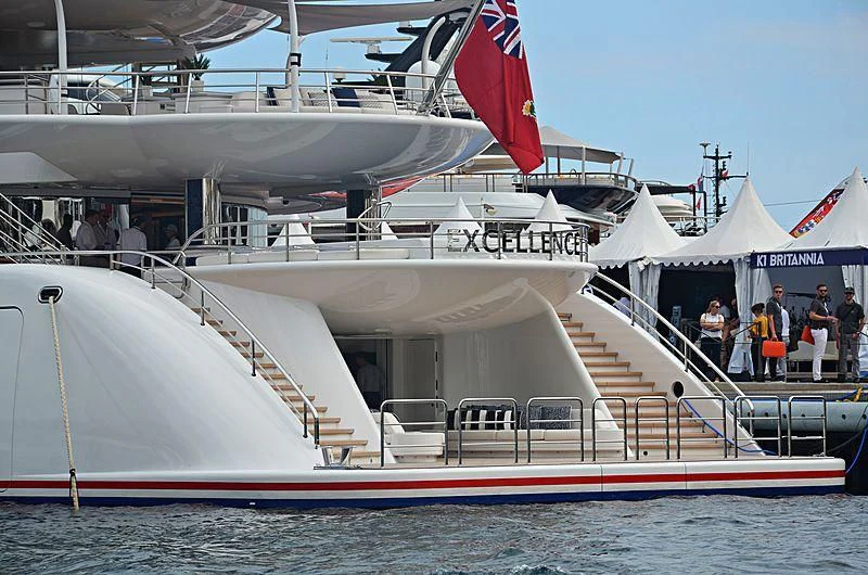 a large white boat with a flag on the front aboard EXCELLENCE Yacht for Sale