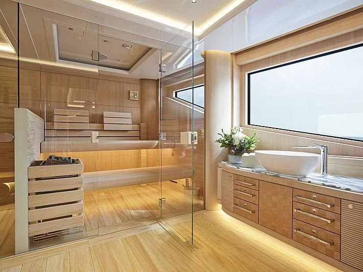 a modern bathroom with wood cabinets aboard EXCELLENCE Yacht for Sale