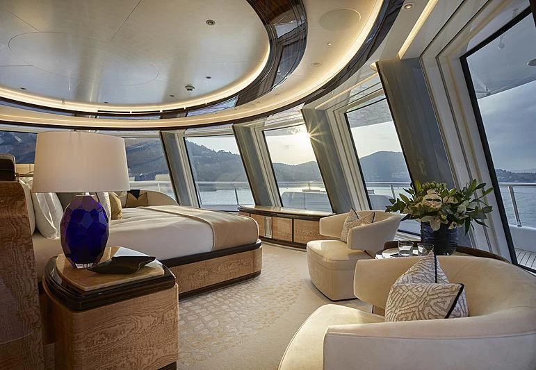 a room with a bed and a large window aboard EXCELLENCE Yacht for Sale