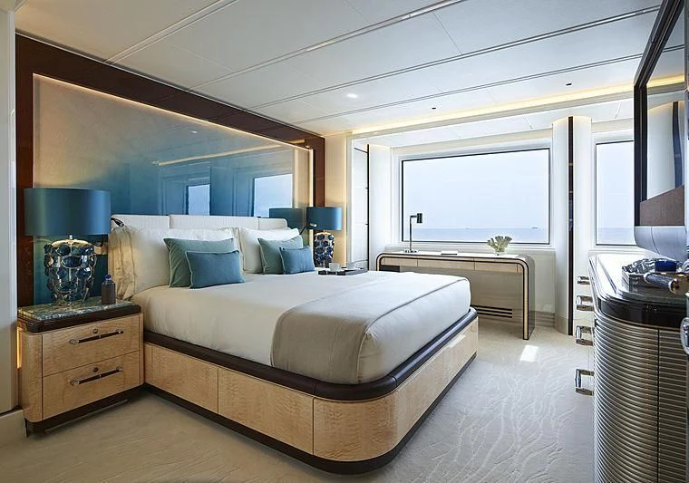 a bedroom with a large bed aboard EXCELLENCE Yacht for Sale