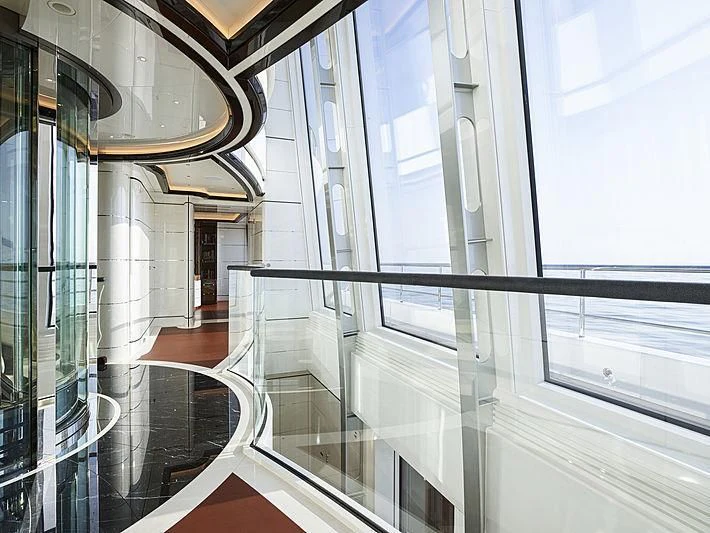 a hallway with glass walls aboard EXCELLENCE Yacht for Sale