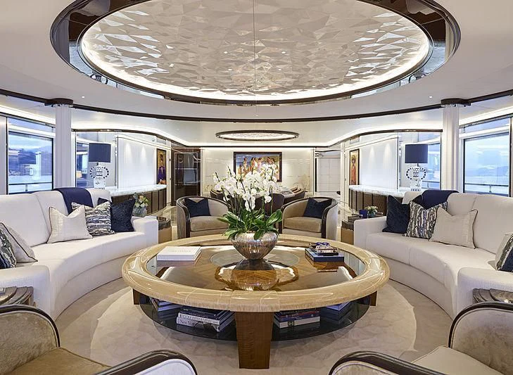 a living room with a large chandelier aboard EXCELLENCE Yacht for Sale