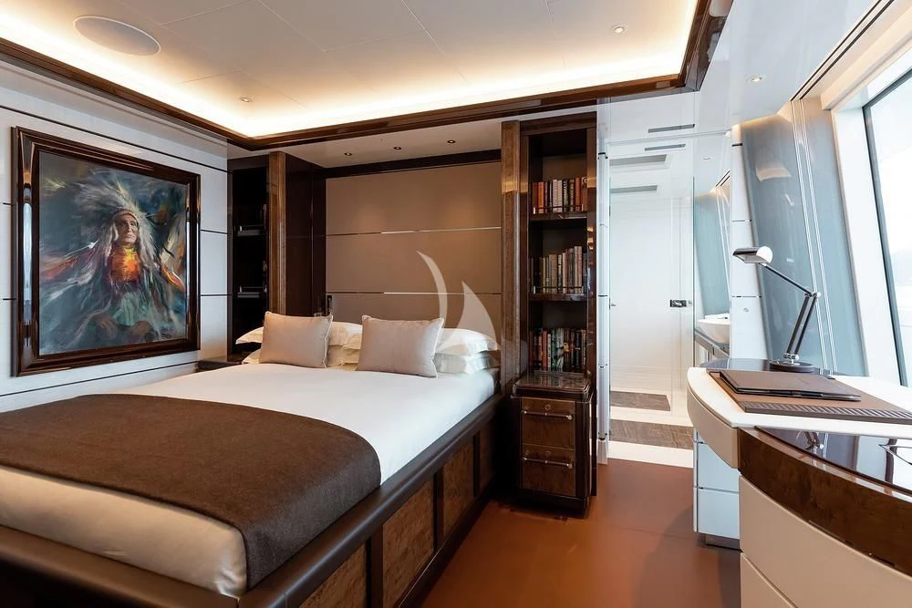 a bedroom with a bed and a bookcase aboard EXCELLENCE Yacht for Sale