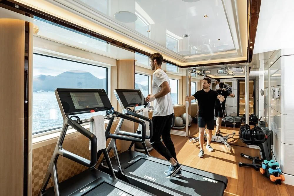 a group of people in a room with computers and a window aboard EXCELLENCE Yacht for Sale