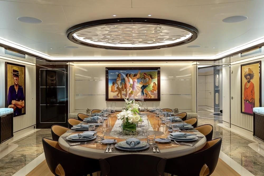 a dining room with a chandelier aboard EXCELLENCE Yacht for Sale