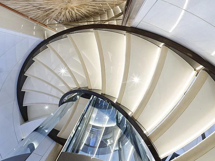 a spiral staircase in a building aboard EXCELLENCE Yacht for Sale