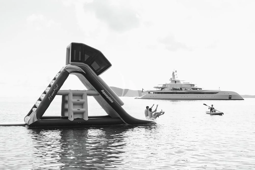 a boat and a couple people in the water aboard EXCELLENCE Yacht for Sale