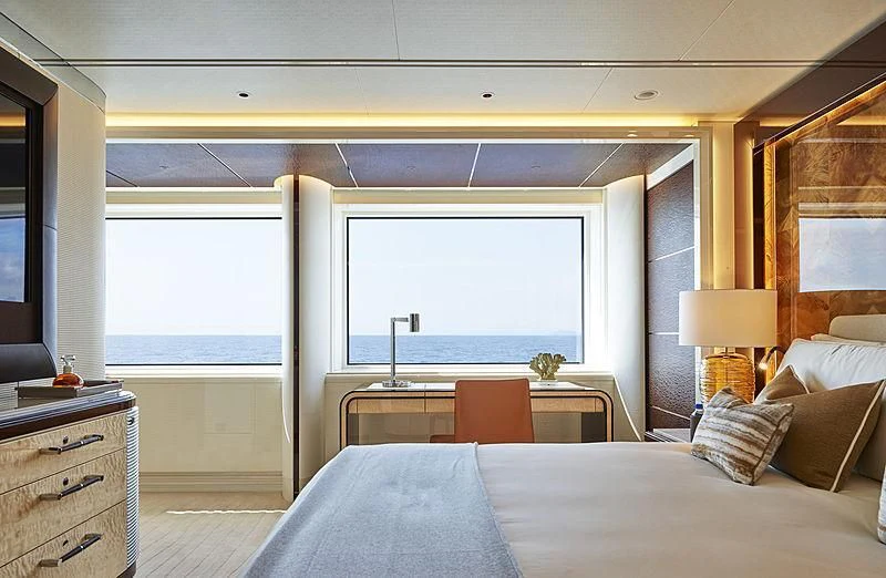 a bedroom with a large window aboard EXCELLENCE Yacht for Sale