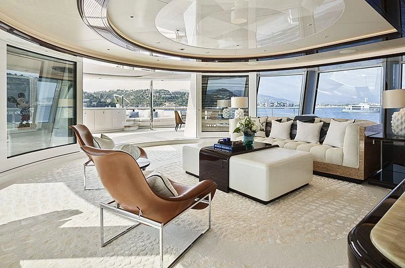 a room with a couch and a table and chairs aboard EXCELLENCE Yacht for Sale