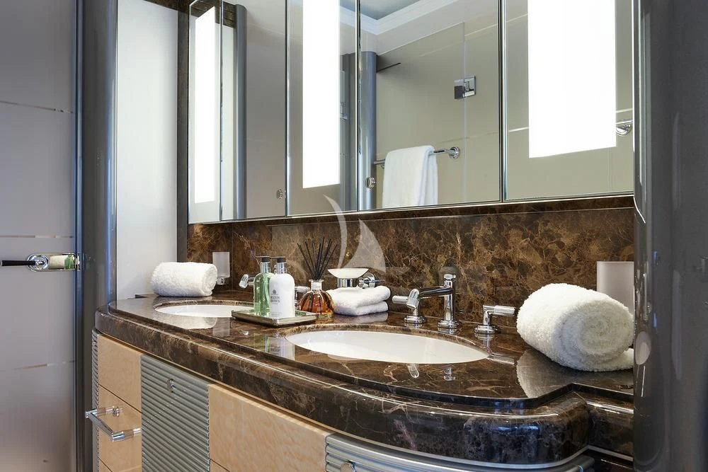 a bathroom with a large mirror aboard EXCELLENCE Yacht for Sale