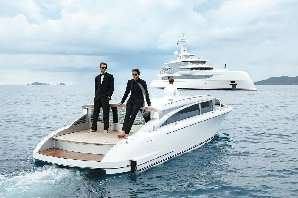 a group of men standing on a boat in the water aboard EXCELLENCE Yacht for Sale
