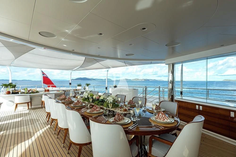 a dining room with a large window aboard EXCELLENCE Yacht for Sale