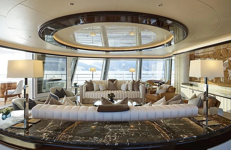 a living room with a large chandelier aboard EXCELLENCE Yacht for Sale