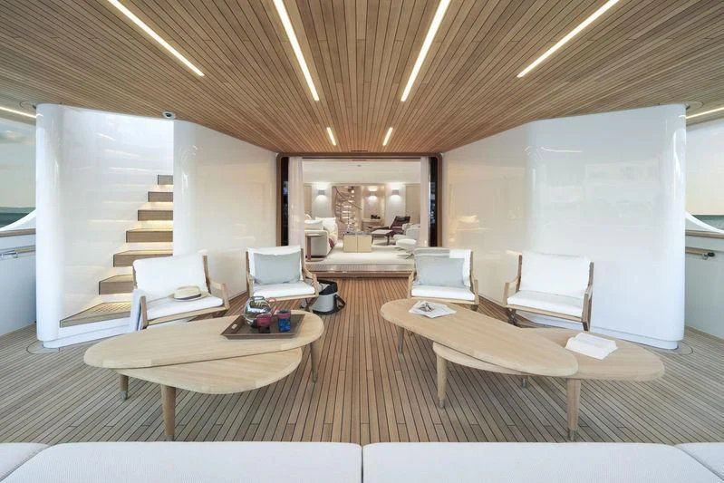 a room with a table chairs and a couch aboard LADY KATHLEEN Yacht for Sale