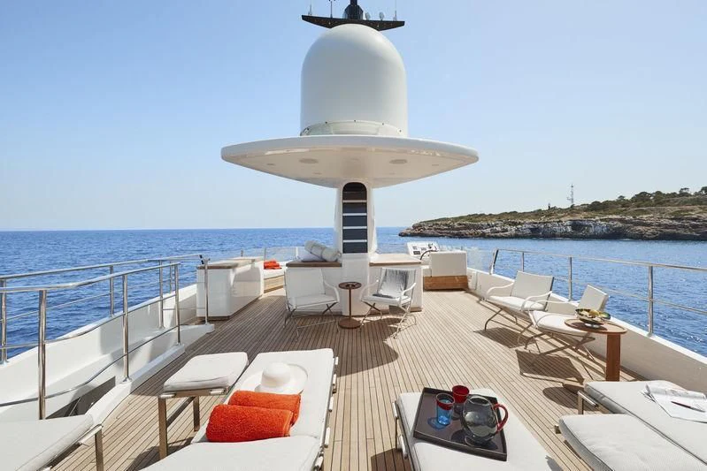 a deck with a table and chairs on it aboard LADY KATHLEEN Yacht for Sale