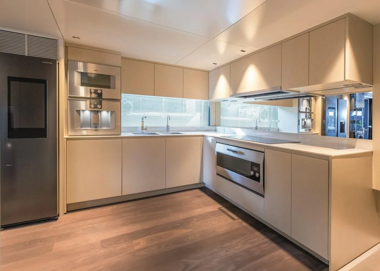 a kitchen with white cabinets aboard NADA Yacht for Sale