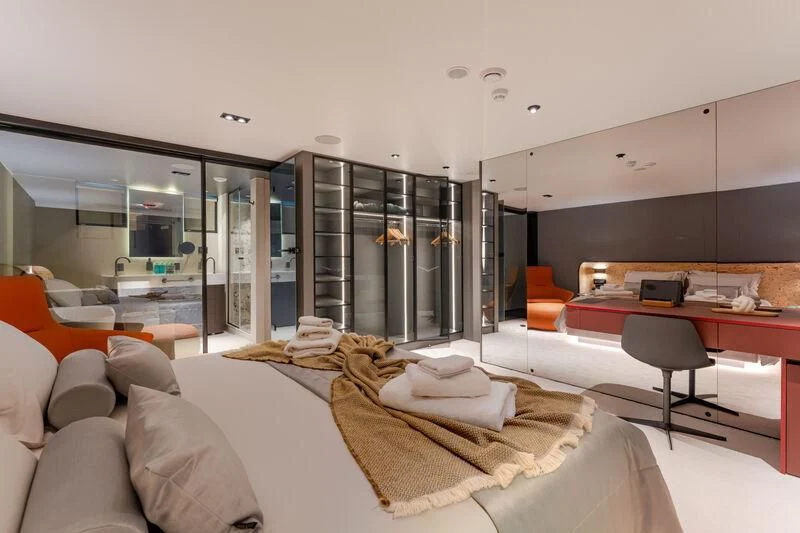 a room with a bed and a desk aboard ANETTA Yacht for Charter