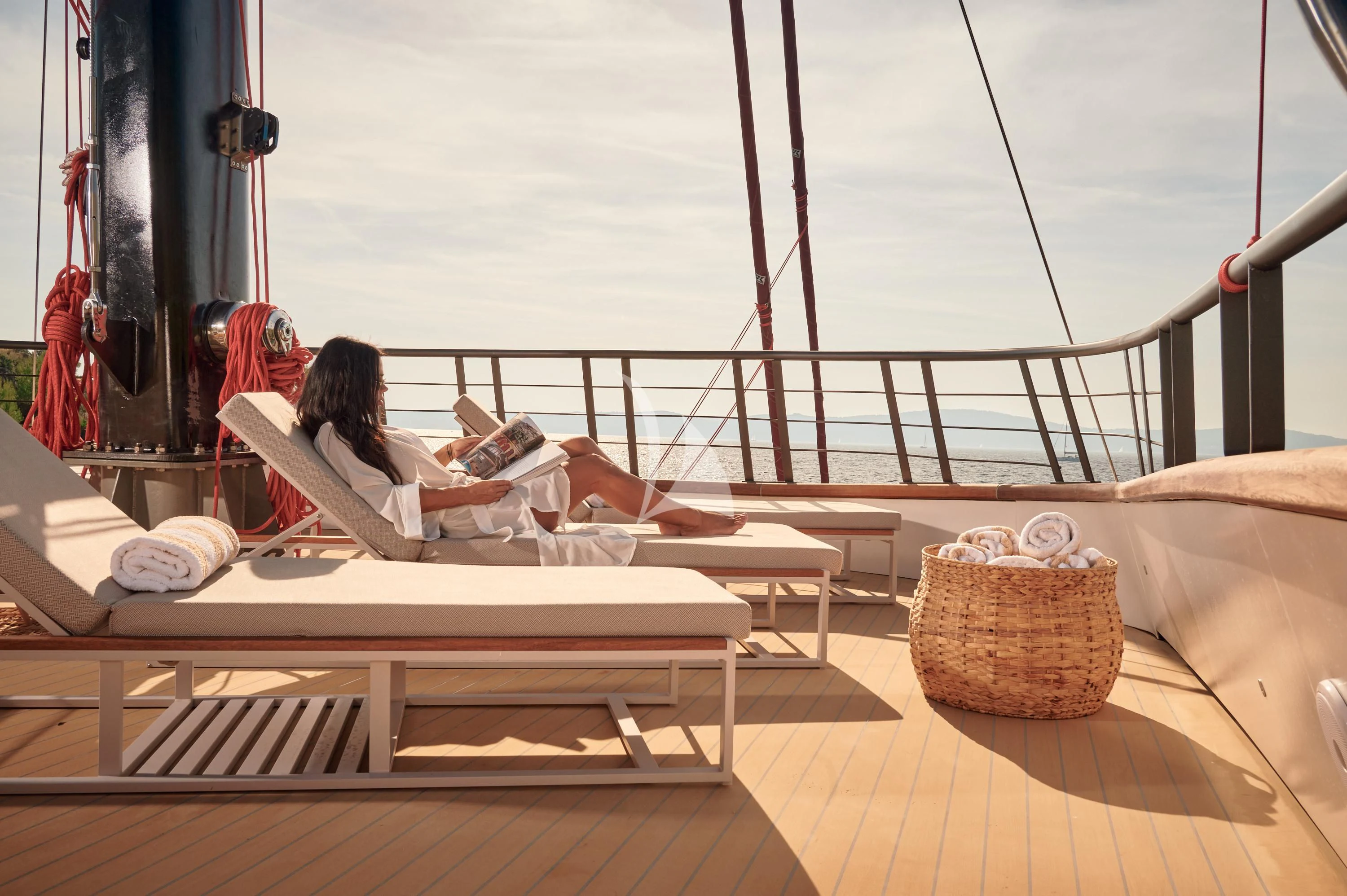a person reading a book on a boat aboard ANETTA Yacht for Charter