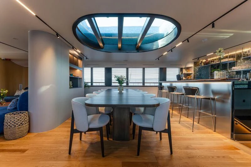 a large room with a table and chairs aboard ANETTA Yacht for Charter