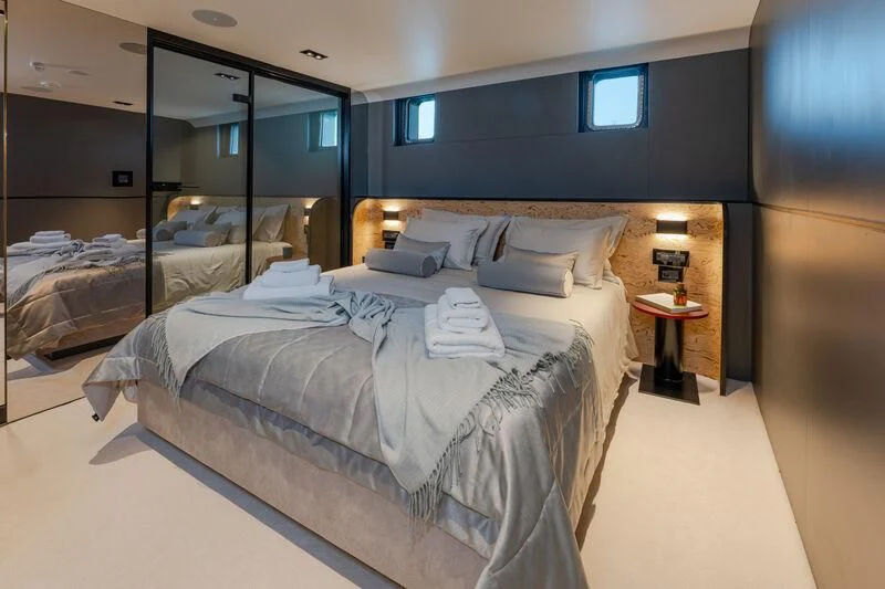 a bedroom with a large mirror aboard ANETTA Yacht for Charter