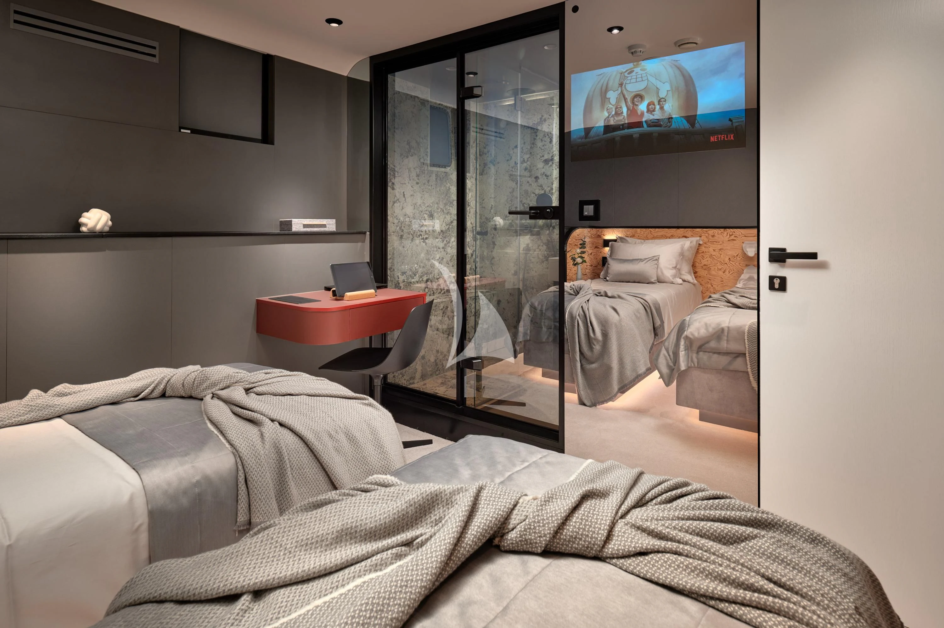 a bedroom with a tv on the wall aboard ANETTA Yacht for Charter