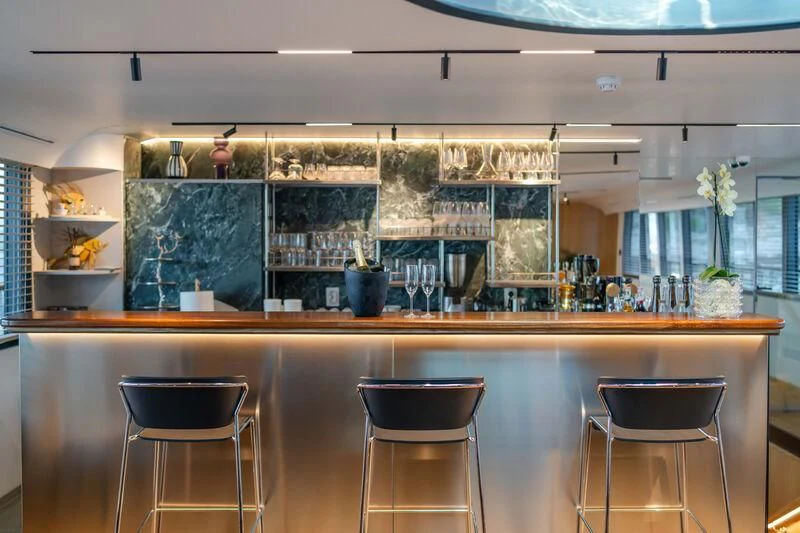 a kitchen with a counter and chairs aboard ANETTA Yacht for Charter