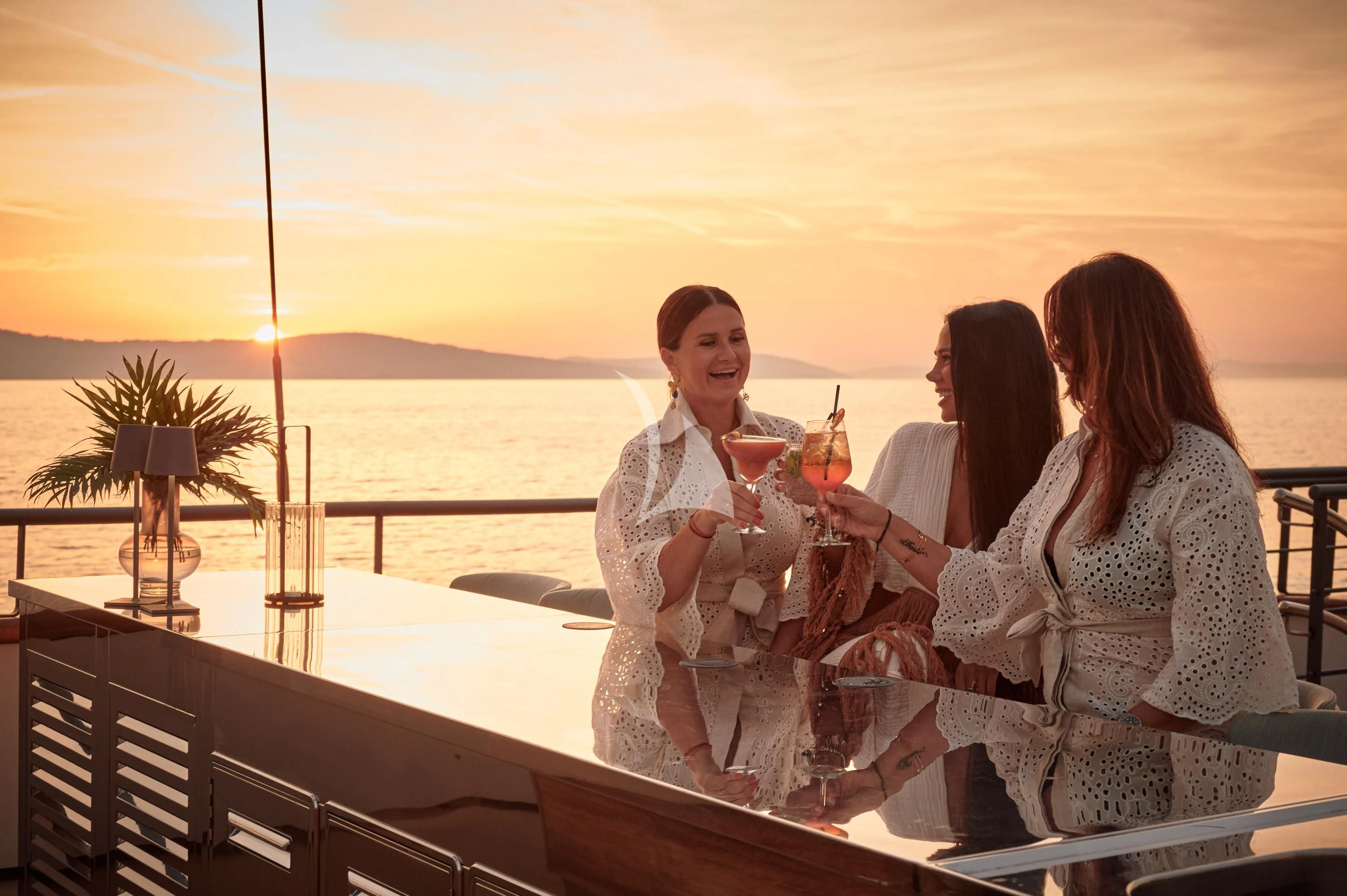 a group of people sitting on a deck overlooking the ocean aboard ANETTA Yacht for Charter