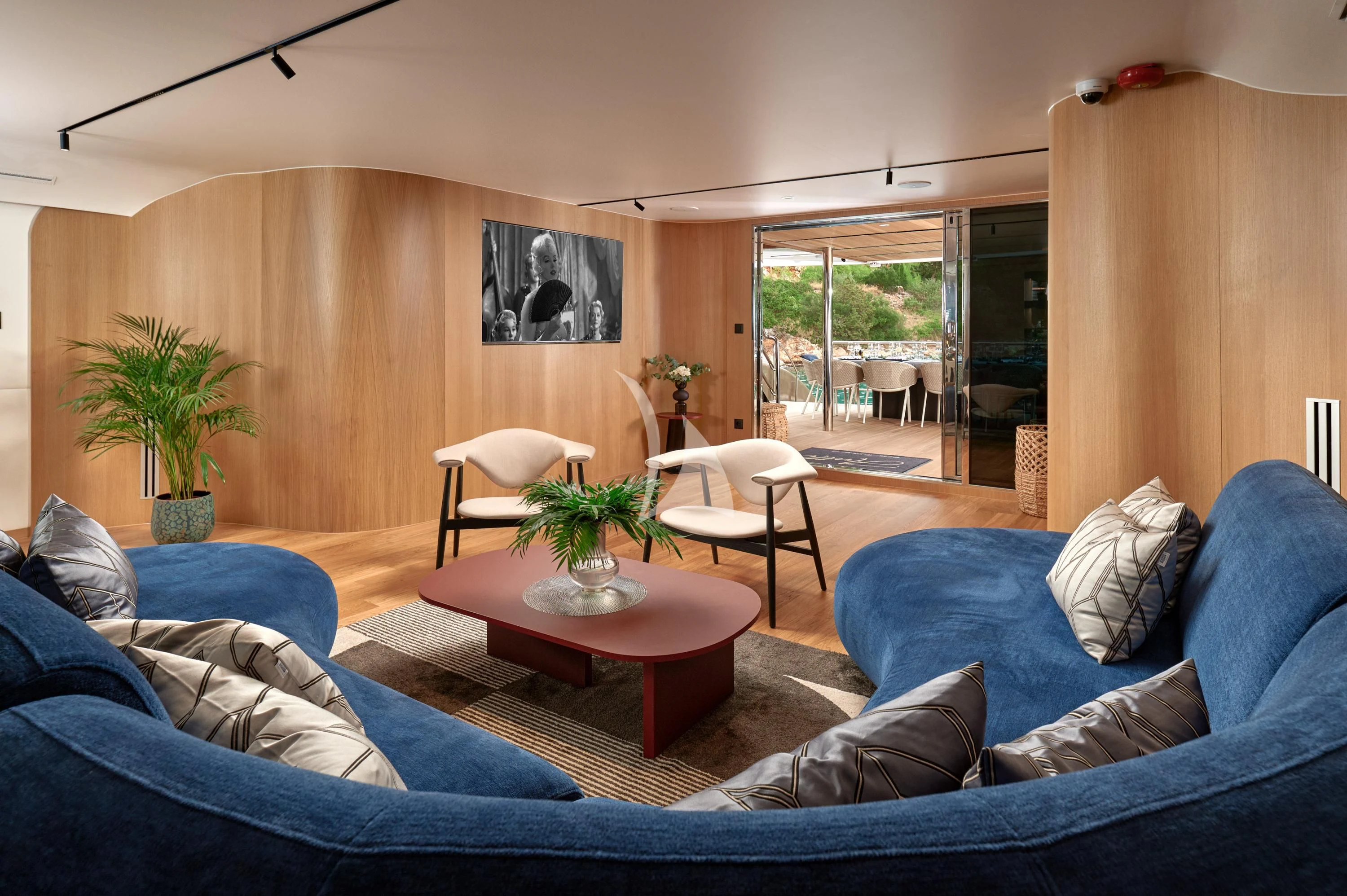 a living room with a blue couch and a coffee table aboard ANETTA Yacht for Charter