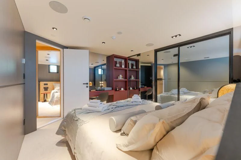 a bedroom with a large mirror aboard ANETTA Yacht for Charter