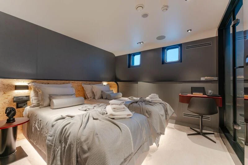 a bedroom with a bed and desk aboard ANETTA Yacht for Charter