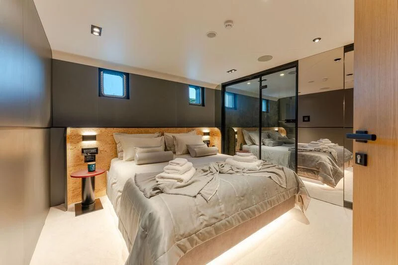 a room with a bed and a mirror aboard ANETTA Yacht for Charter