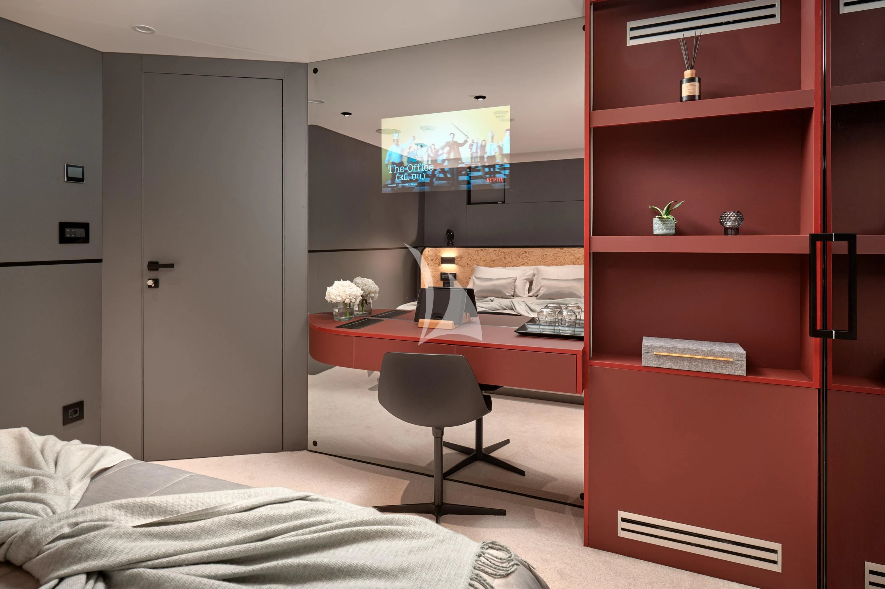 a bedroom with a desk and a bed aboard ANETTA Yacht for Charter